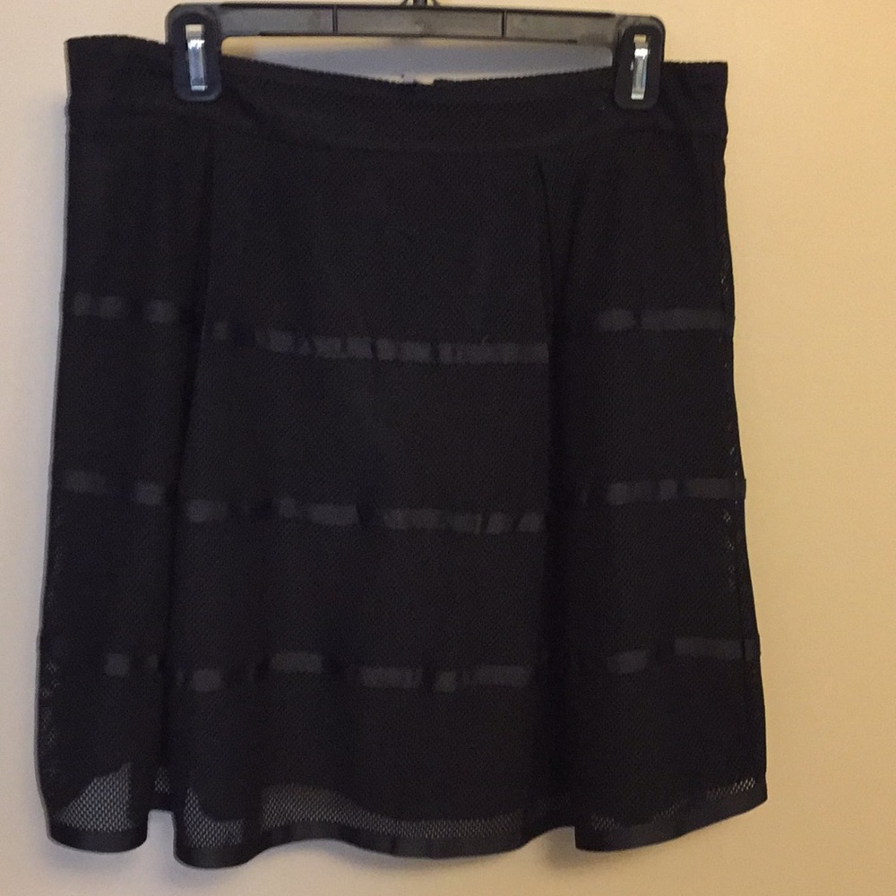 Black skirt. Mesh top with ribbons. Lined